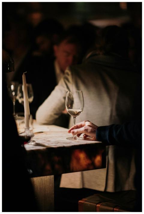 Sophisticated wine tasting in a cozy, dimly lit ba