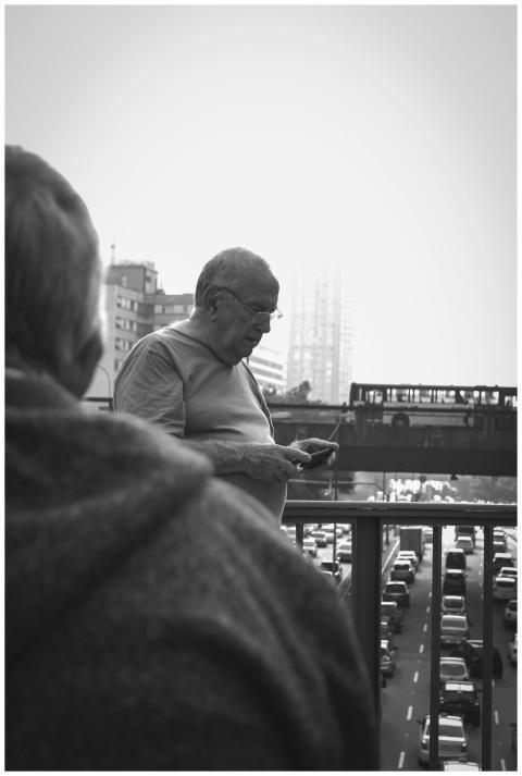 A black and white image of people and vehicles on