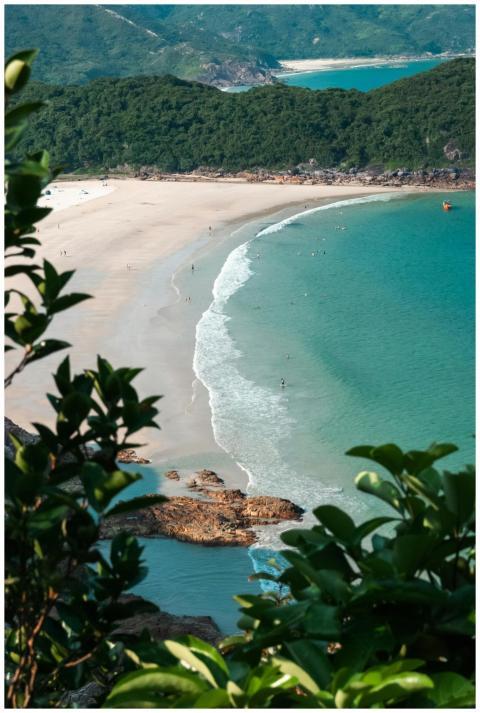 A scenic aerial view of a secluded beach cove surr