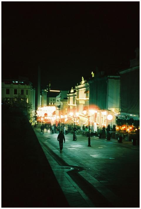 A bustling illuminated street in Moscow at night w