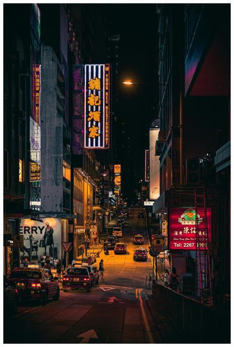 Explore the bustling streets of Hong Kong at night