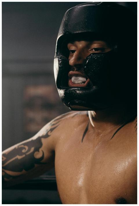 Portrait of a determined boxer in head guard durin