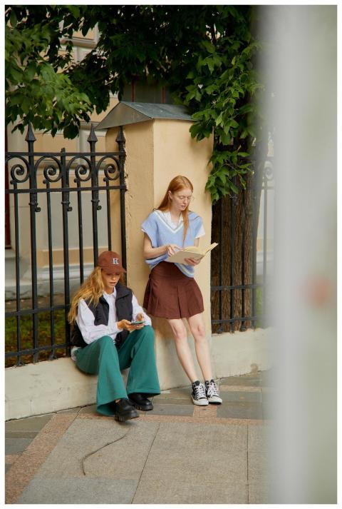 Two young women enjoying a reading break near an i