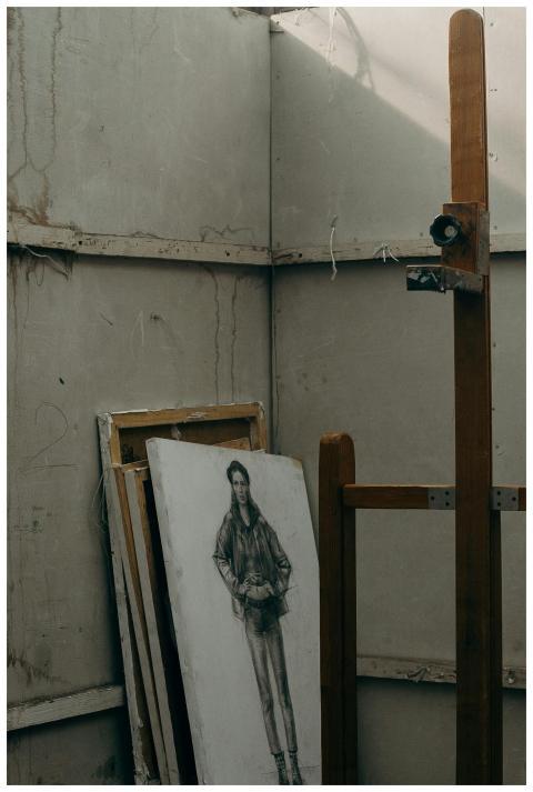 Dimly lit art studio with sketch on canvas resting