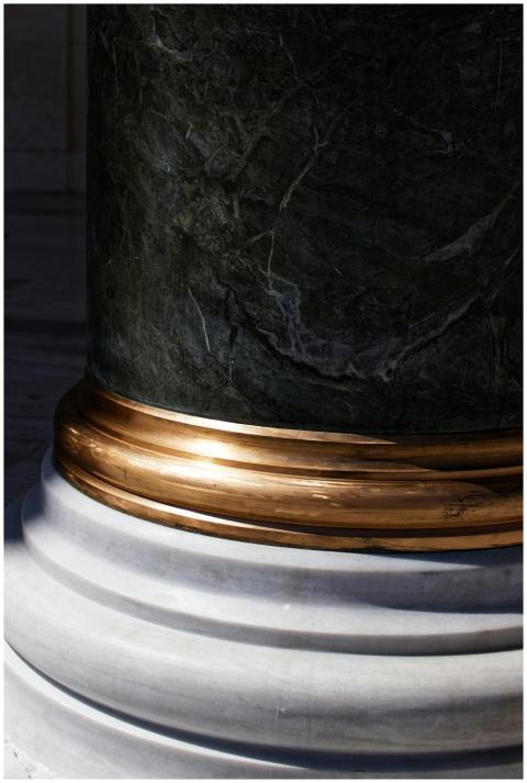 High-quality close-up of a marble column with gold