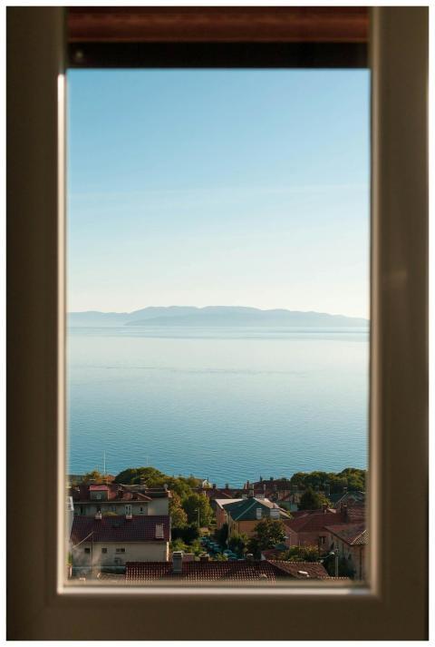 Serene view of the Adriatic Sea framed by a window