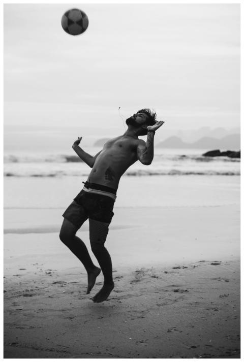 Dynamic black and white image of a man playing soc