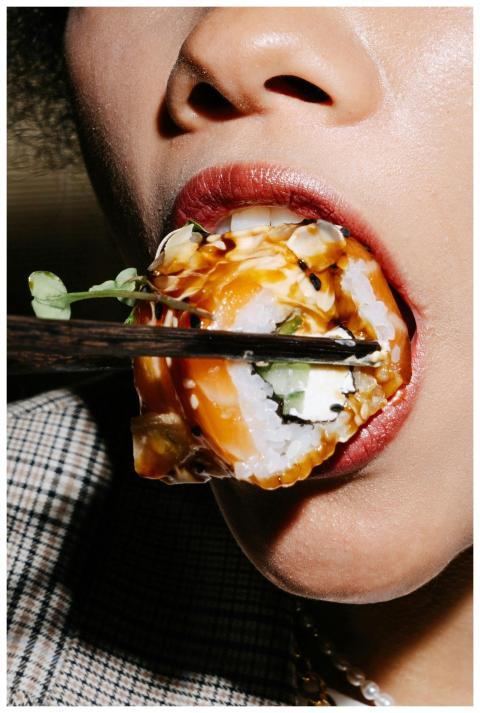 Detailed close-up of a person savoring sushi using