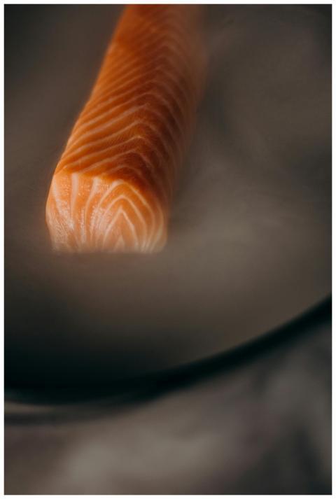 Close-up of a fresh salmon fillet enveloped in ste