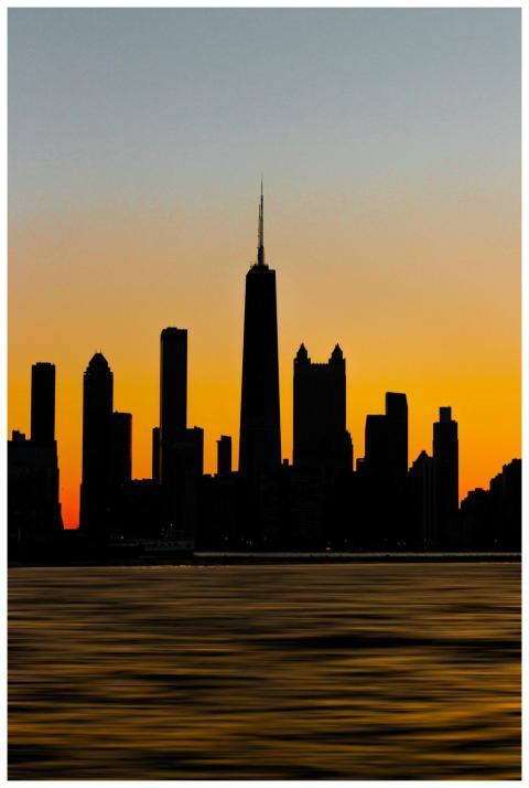 Silhouette of the Chicago skyline against a vibran