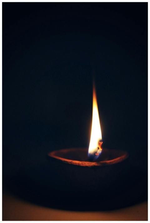 A close-up capture of a candle's flame illuminatin