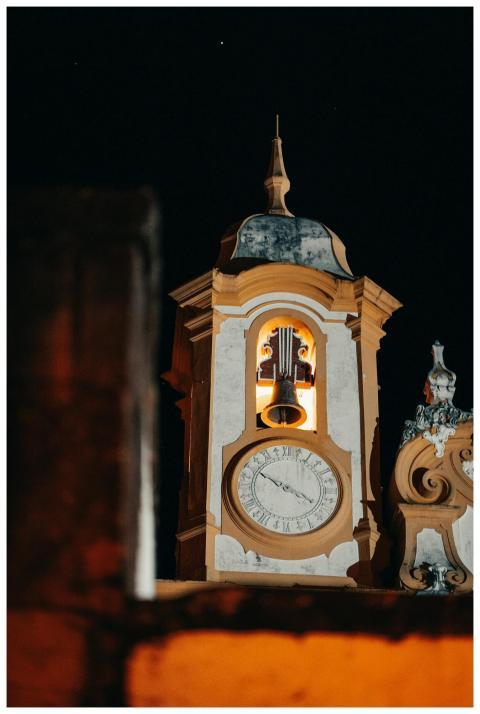 Illuminated baroque church tower against the night
