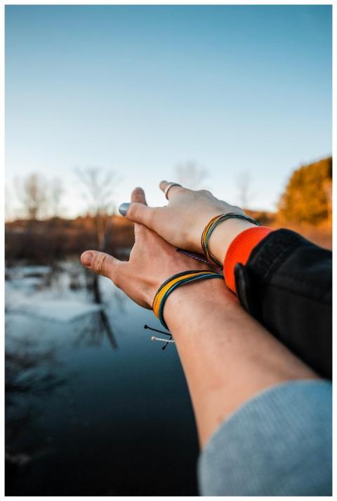 A couple embracing a romantic moment by a serene l