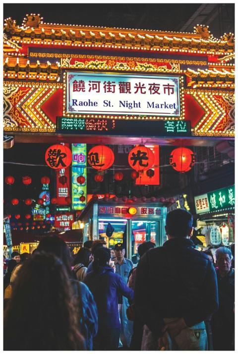 Vibrant crowd and neon signs at the lively Raohe S