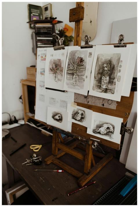 A cozy art studio with detailed still life paintin