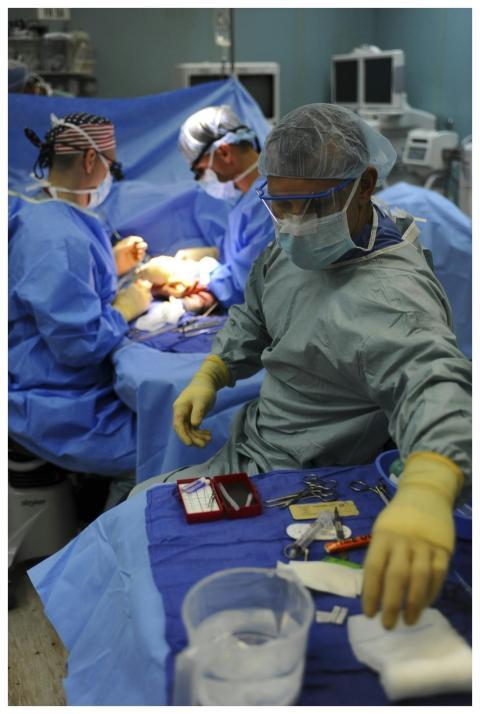 Team of surgeons in a hospital operating room cond