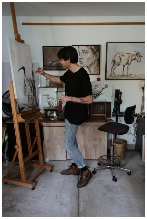 Detailed view of an artist painting in a creative