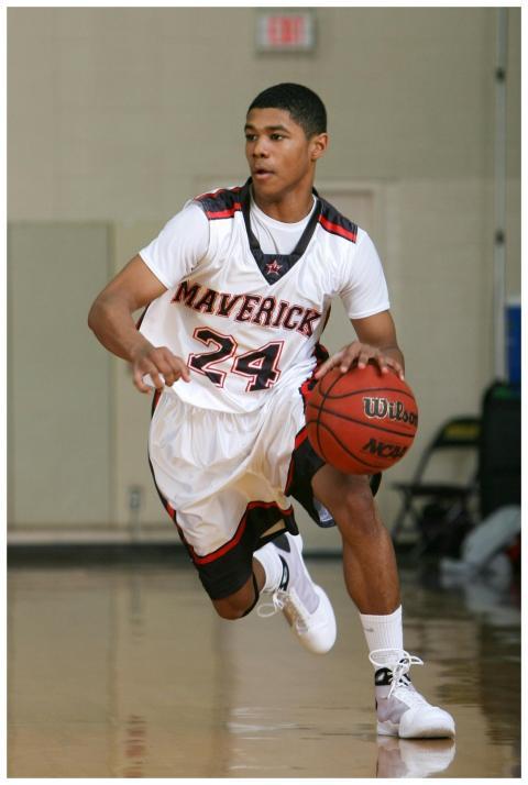 A young male basketball player dribbles on an indo