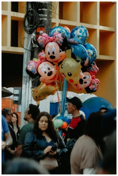 A street vendor selling balloons featuring cartoon