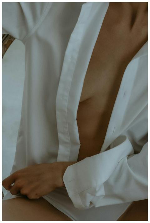 Sensual close-up of a woman in an unbuttoned white