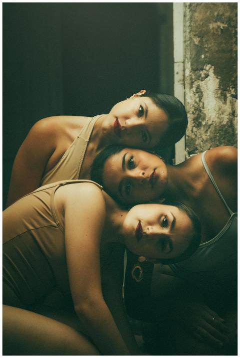 Beautiful artistic portrait of three women with ti