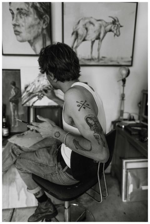 Black and white side view of anonymous tattooed ma