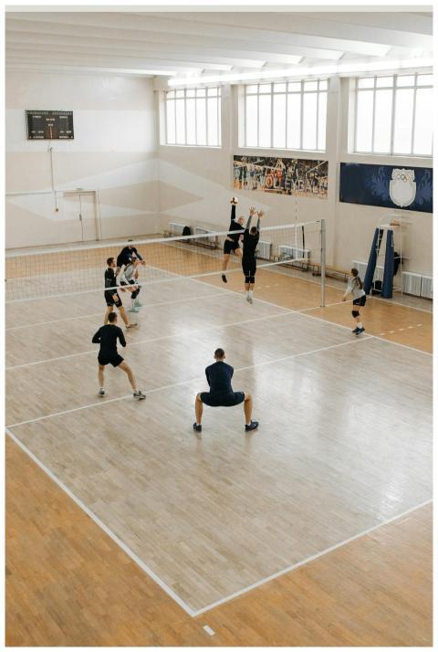 A dynamic indoor volleyball match showcasing teamw