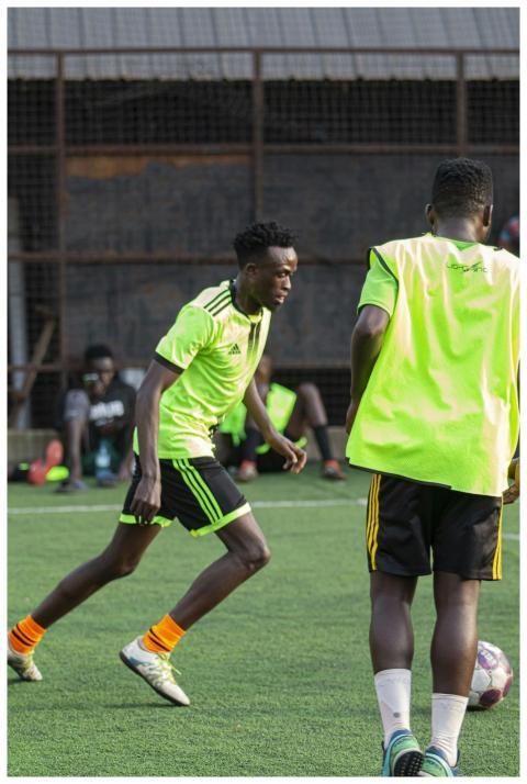 Two young male soccer players compete during a pra