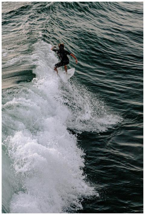 A surfer skillfully rides a wave in the ocean duri