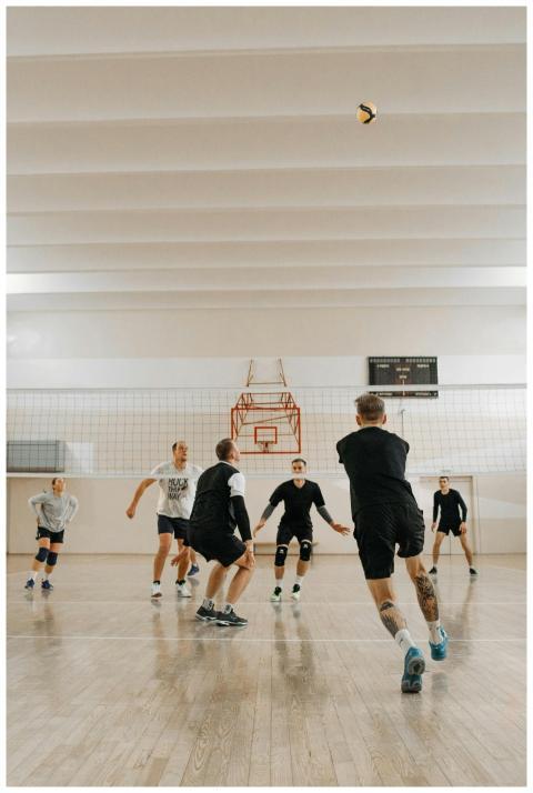 Energetic indoor volleyball game with six players