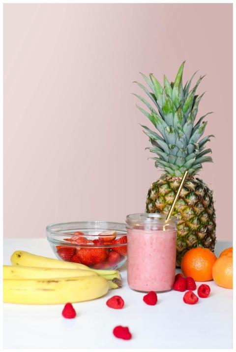 A vibrant smoothie with pineapple, banana, and ber