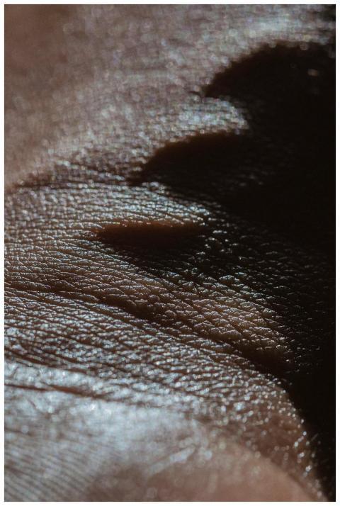 Closeup full frame hand of crop unrecognizable Afr