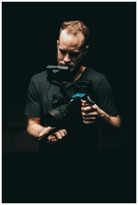 A cinematographer adjusts a camera rig with precis