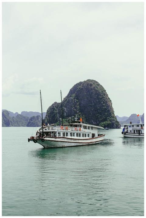 A serene landscape of a cruise boat sailing throug