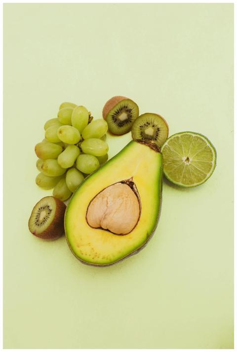 Vibrant fresh avocado, kiwi, lime, and grapes on a