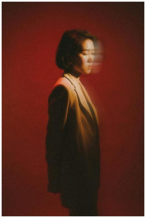 Artistic portrait featuring a woman in blurred mot