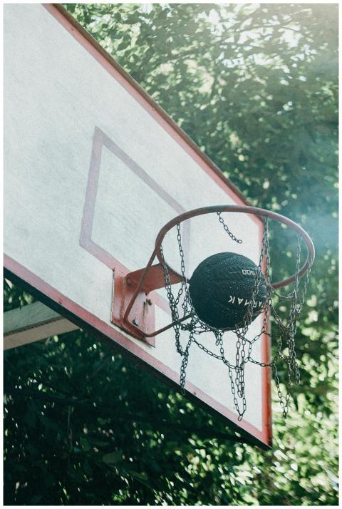 A basketball passing through a chain net on an out