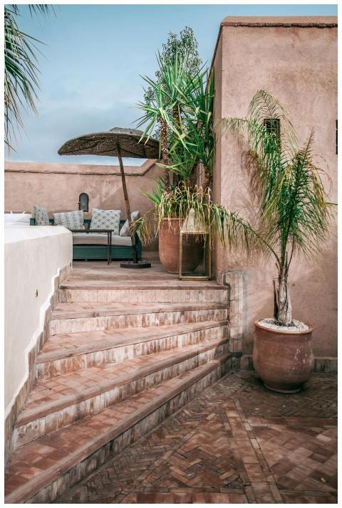 Idyllic villa terrace with stairs, tropical plants