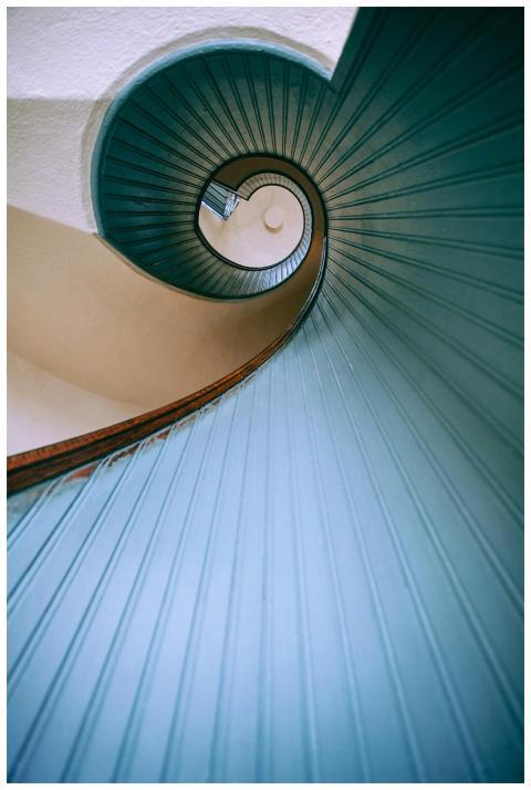 Intriguing low angle view of a blue spiral stairca