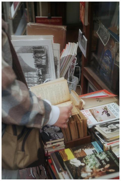 Person browsing books at a street shop in Istanbul