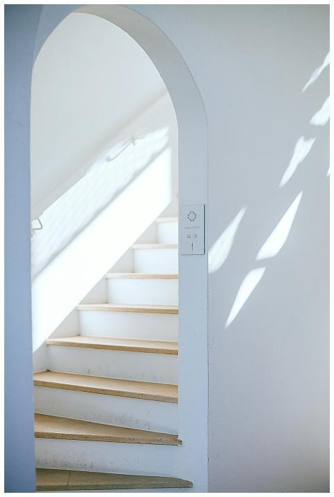 Bright minimalist interior featuring a white stair