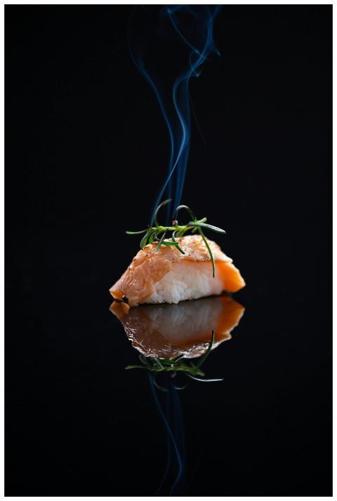 Elegant smoked salmon nigiri sushi with a smoky ar