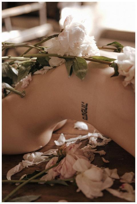 Aesthetic close-up of white peonies on a tattooed