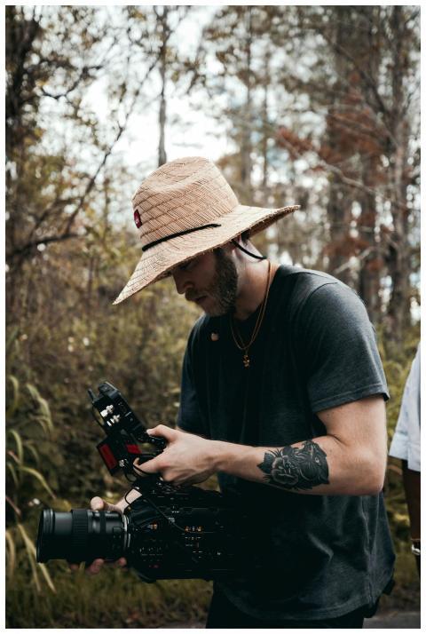 A cinematographer operating a professional camera