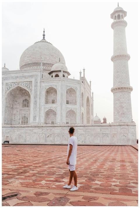 A person standing in front of the Taj Mahal, showc