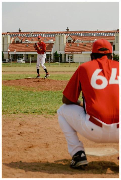 Two baseball players in action on a sunny day, wit