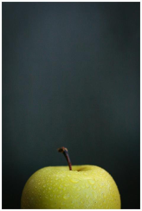 Closeup of green apple covered with drops of water
