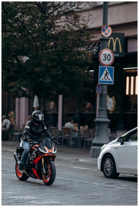 Motorcyclist riding through city street with traff