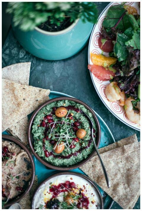Delicious and colorful meal with hummus, salads, a
