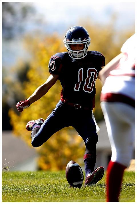 Action shot of a football player kicking the ball